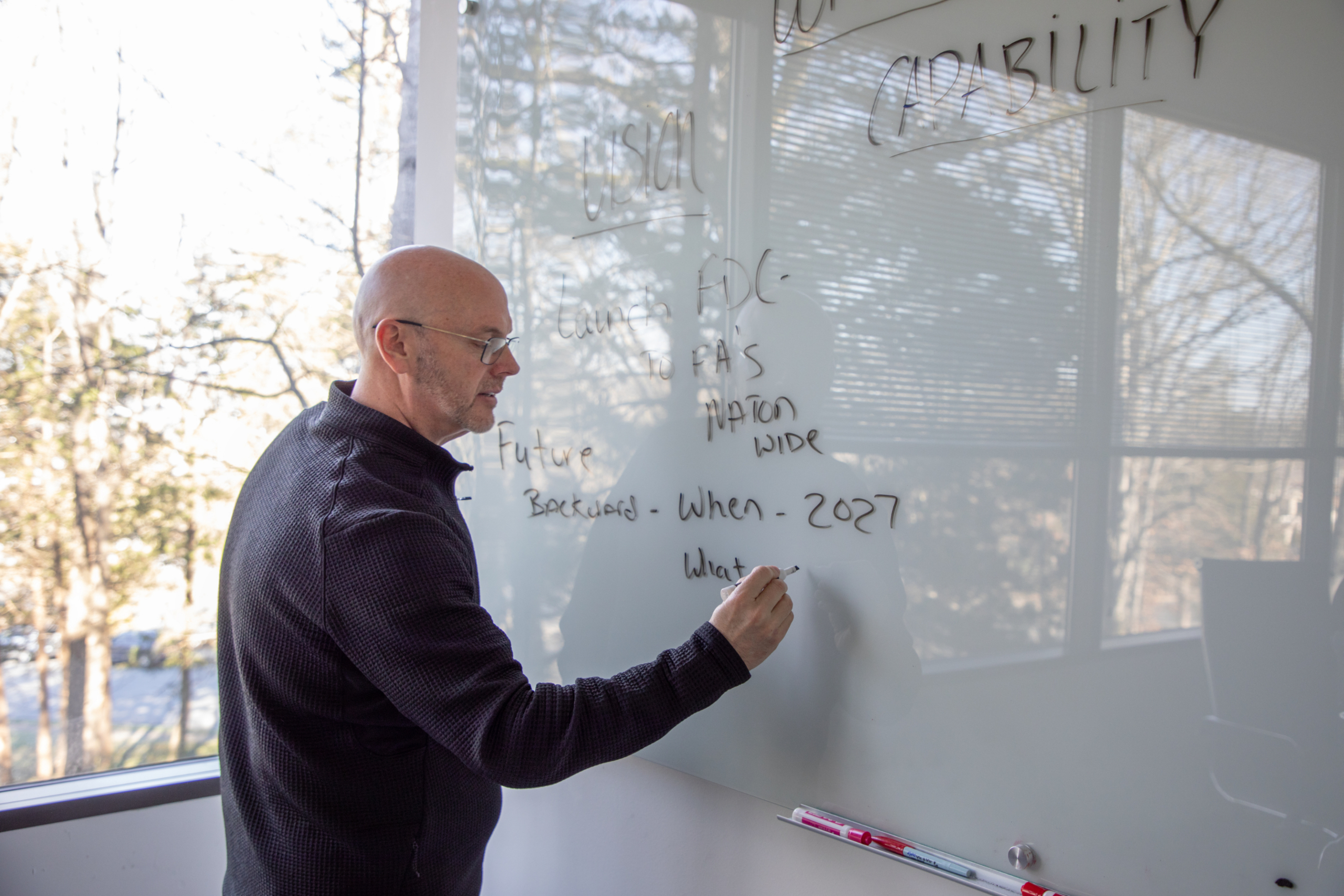 Chad Jenkins Presenting in Front of White Board